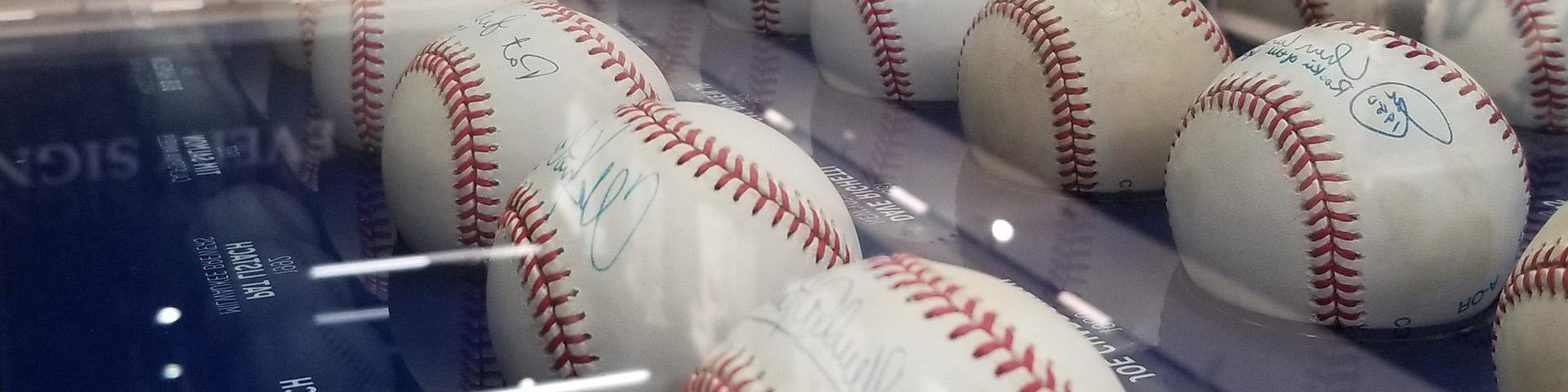 Signed baseballs in an enclosure